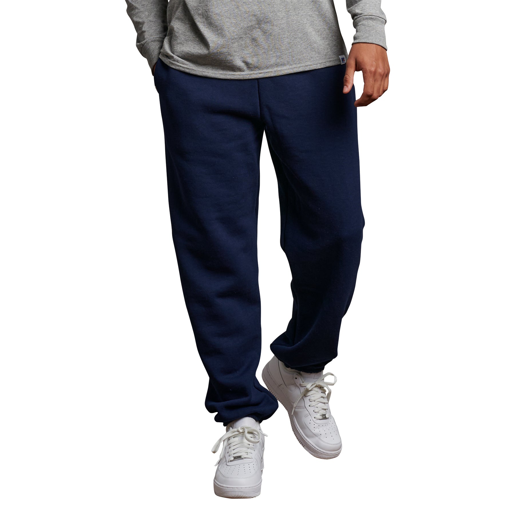 Russell Athletic DRI-POWER adult navy closed-bottom sweatpants with side pockets worn with white sneakers.
