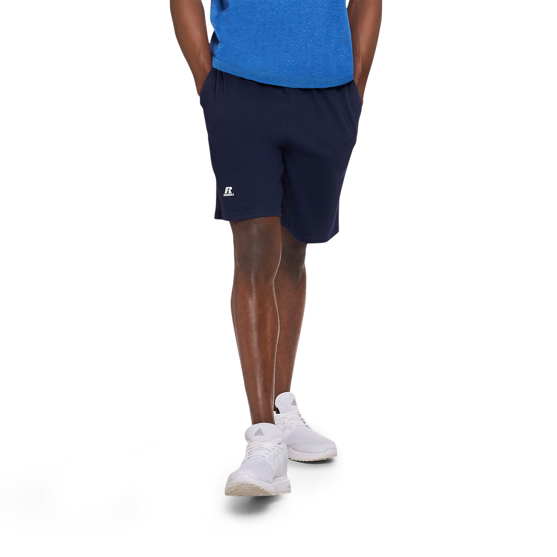Russell Athletic Navy cotton jersey pocketed sweatshorts on a model wearing white sneakers.