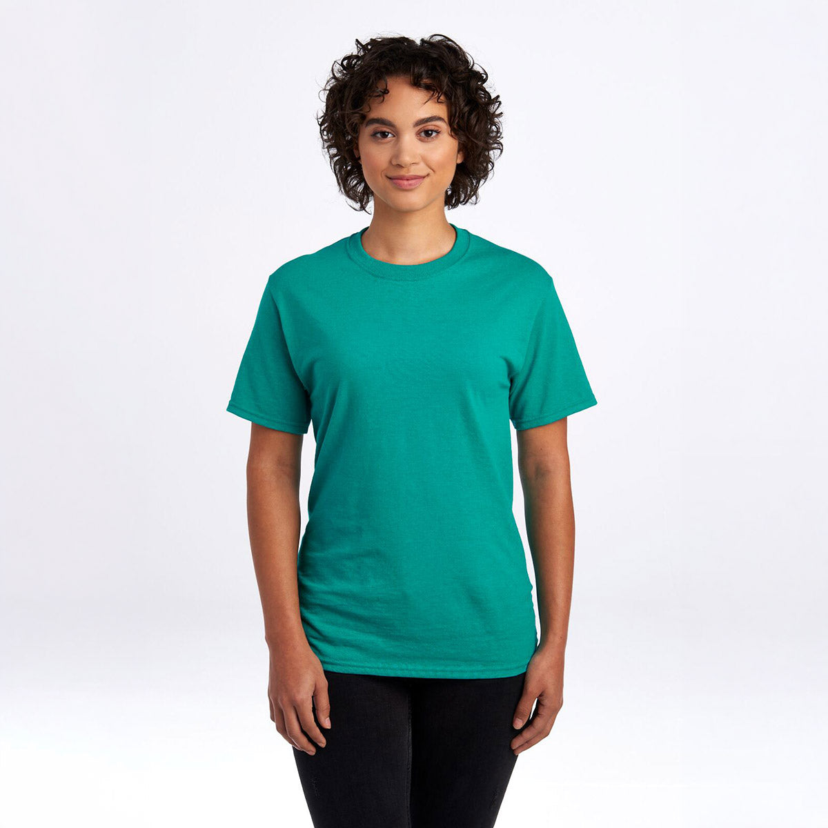 A woman wearing a jade Jerzees Dri-Power Unisex T-shirt against a plain white background.