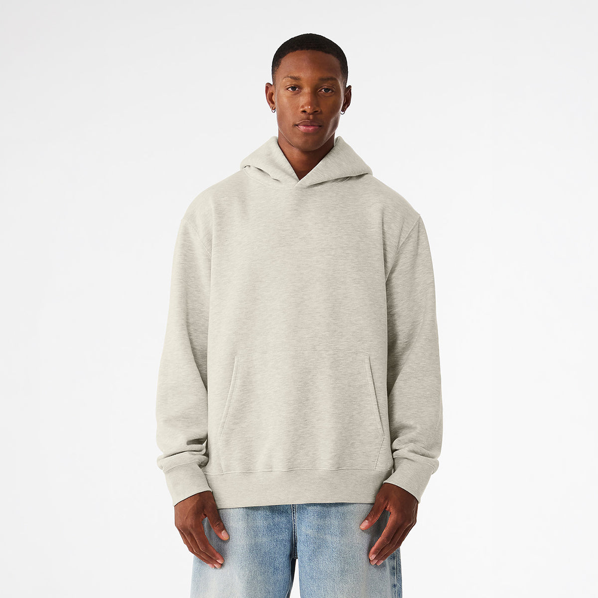 Bella + Canvas Unisex 10 oz Heavyweight Pullover Hoodie in Vintage Heather Grey worn by a man.