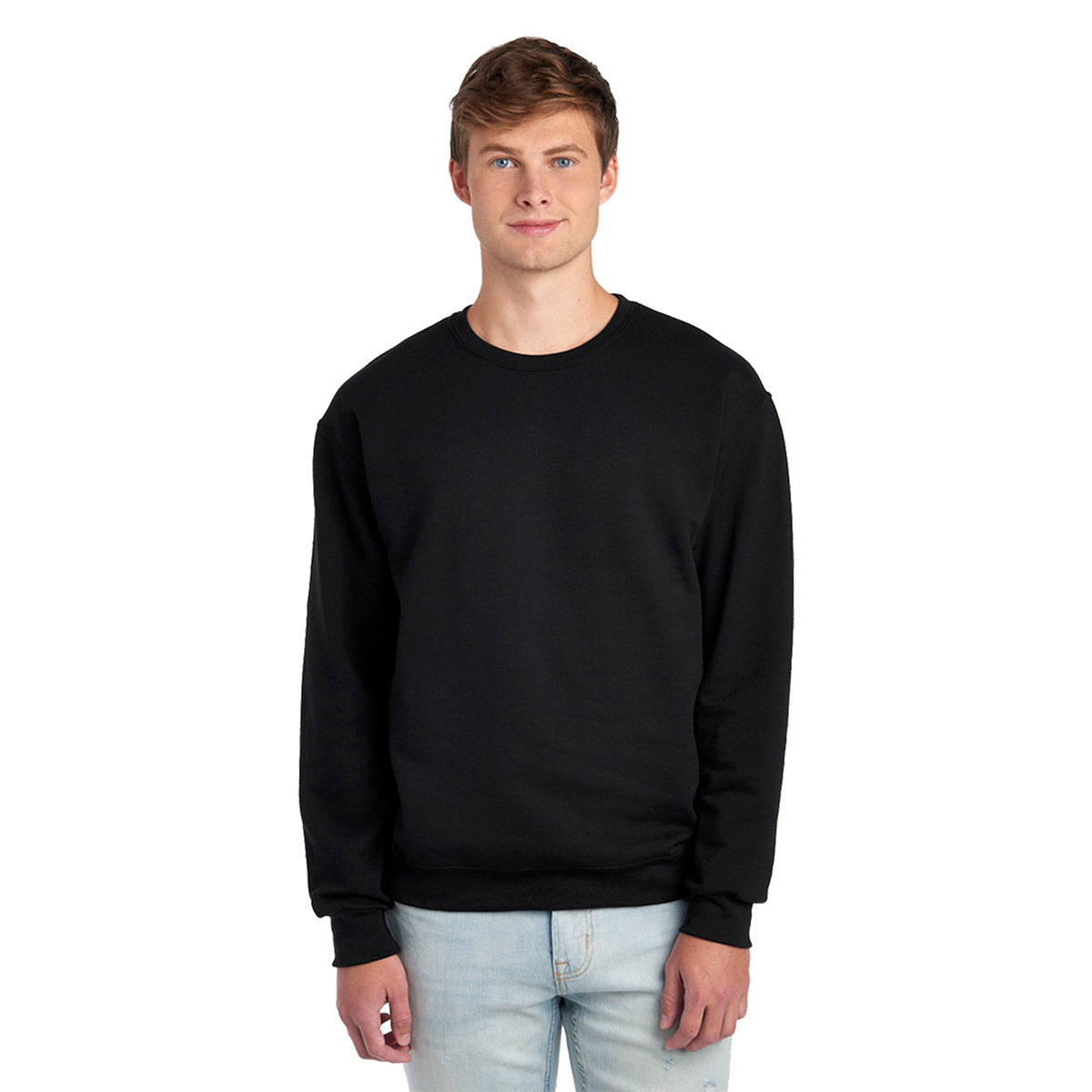 A young man wearing a black Jerzees NuBlend Adult Sweatshirt with a crew neck against a white background.