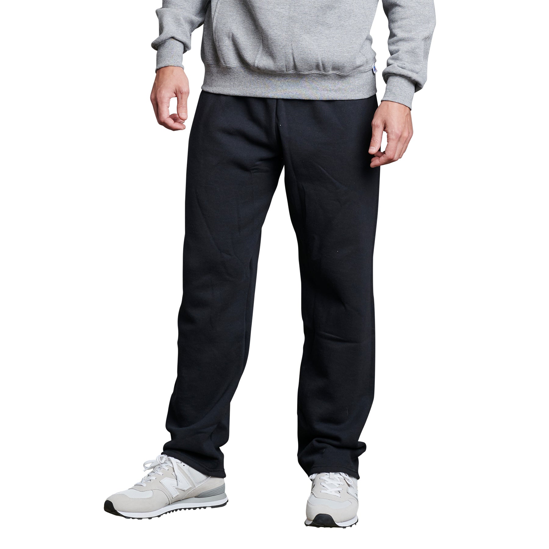 Model wearing Russell Athletic DRI-POWER adult black open-bottom fleece pocketed sweatpants.
