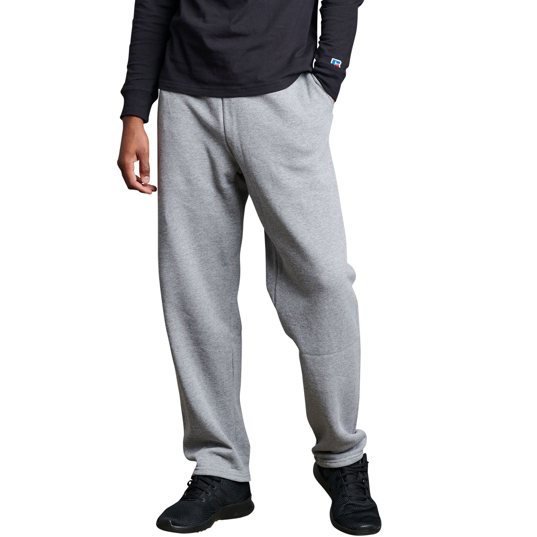 Russell Athletic DRI-POWER adult open-bottom fleece sweatpants in Oxford gray worn with a black long-sleeve shirt.