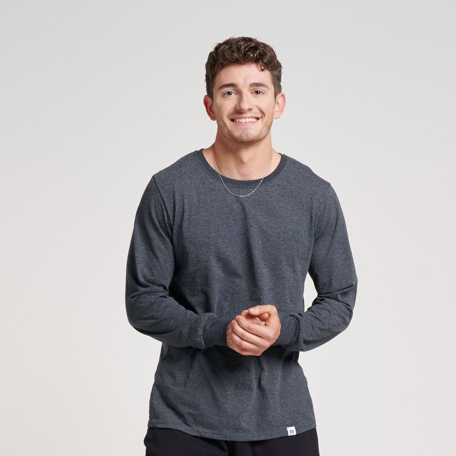 Man wearing a Russell Athletic DRI-POWER CVC Performance unisex long-sleeve T-shirt in black heather.