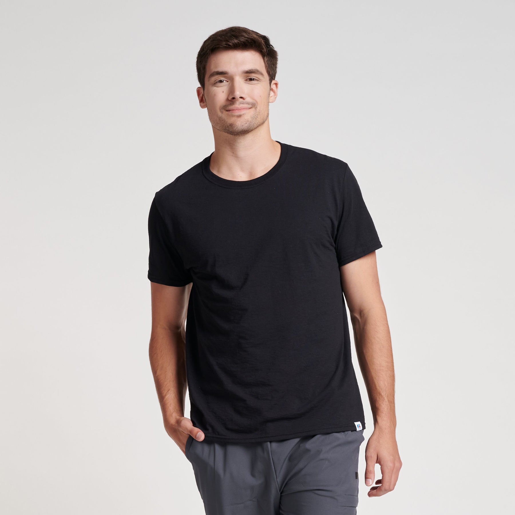 Russell Athletic DRI-POWER CVC Performance unisex black t-shirt worn by a man.