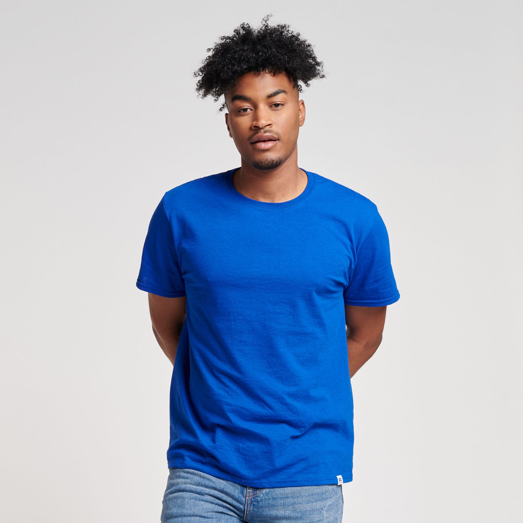 A model wearing a Russell Athletic DRI-POWER CVC Performance royal blue unisex t-shirt.