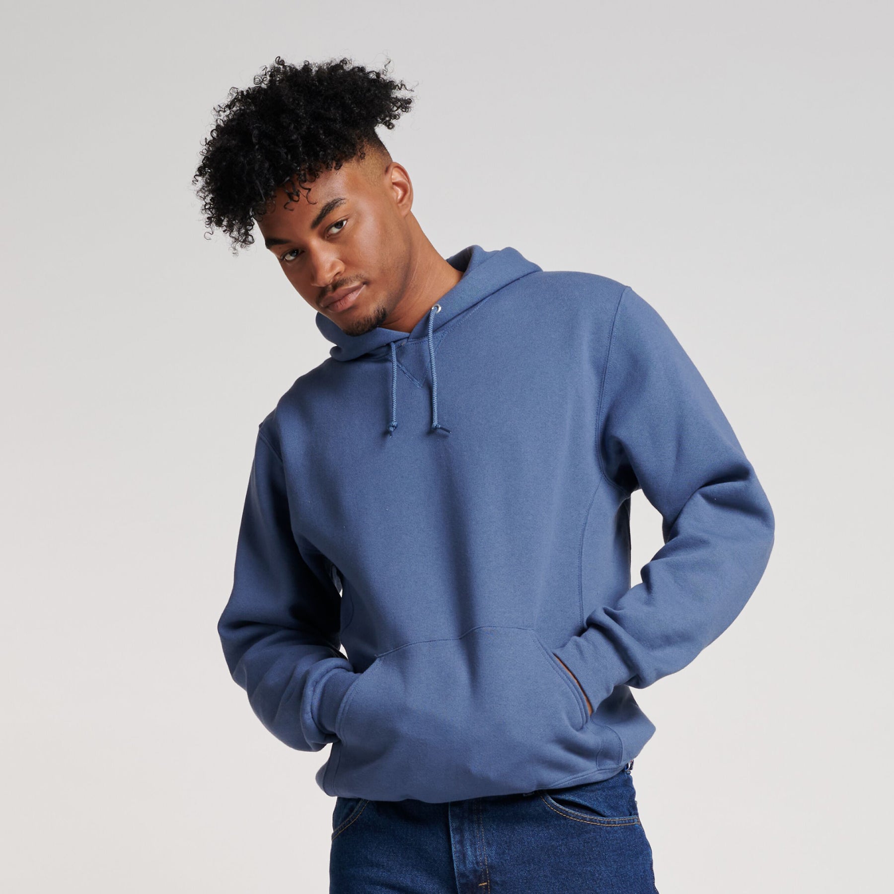 Man wearing a Russell Athletic DRI-POWER Adult Fleece Unisex Hoodie in Vintage Blue.