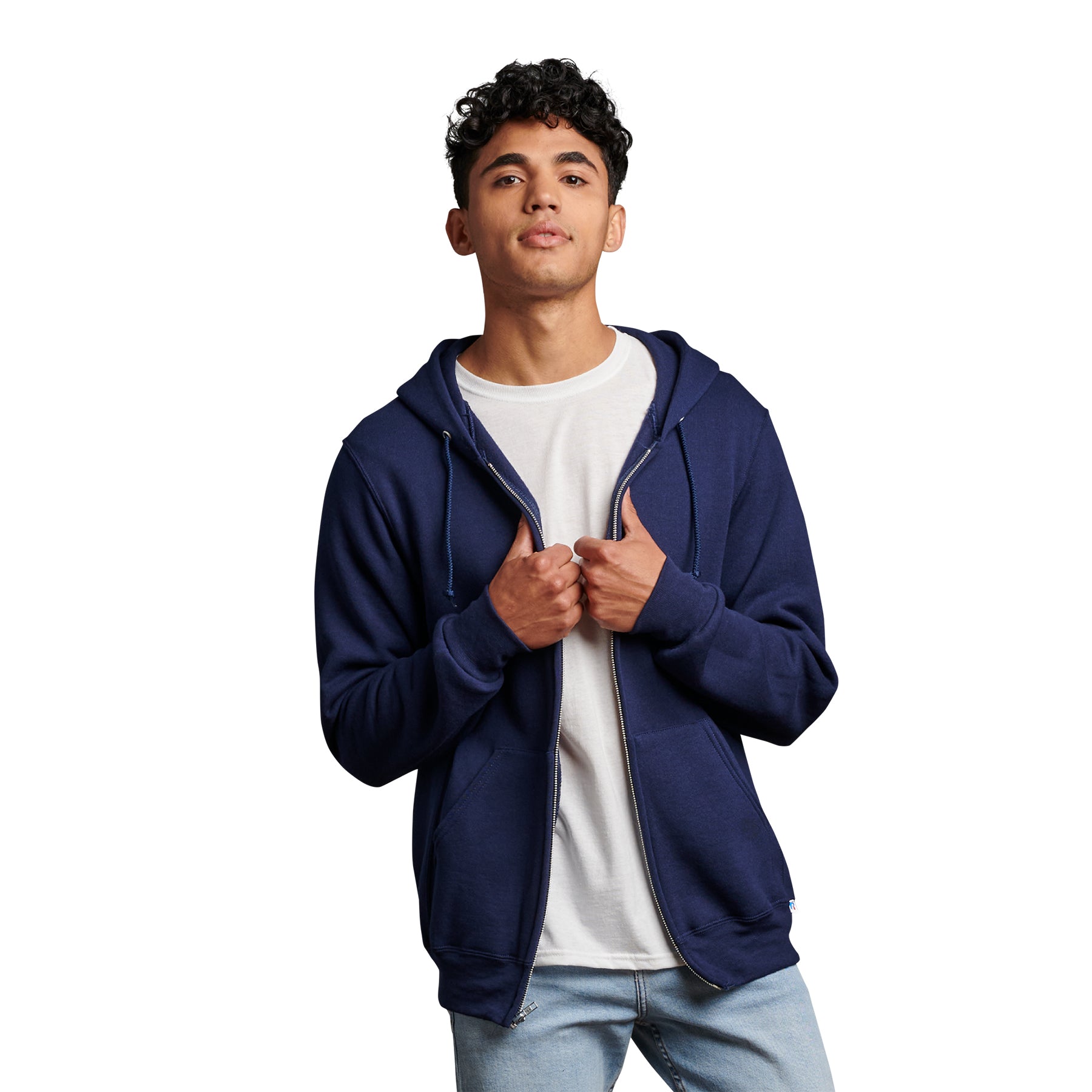 A young man wearing a navy Russell Athletic DRI-POWER Adult Fleece Full-Zip Hoodie over a white t-shirt.