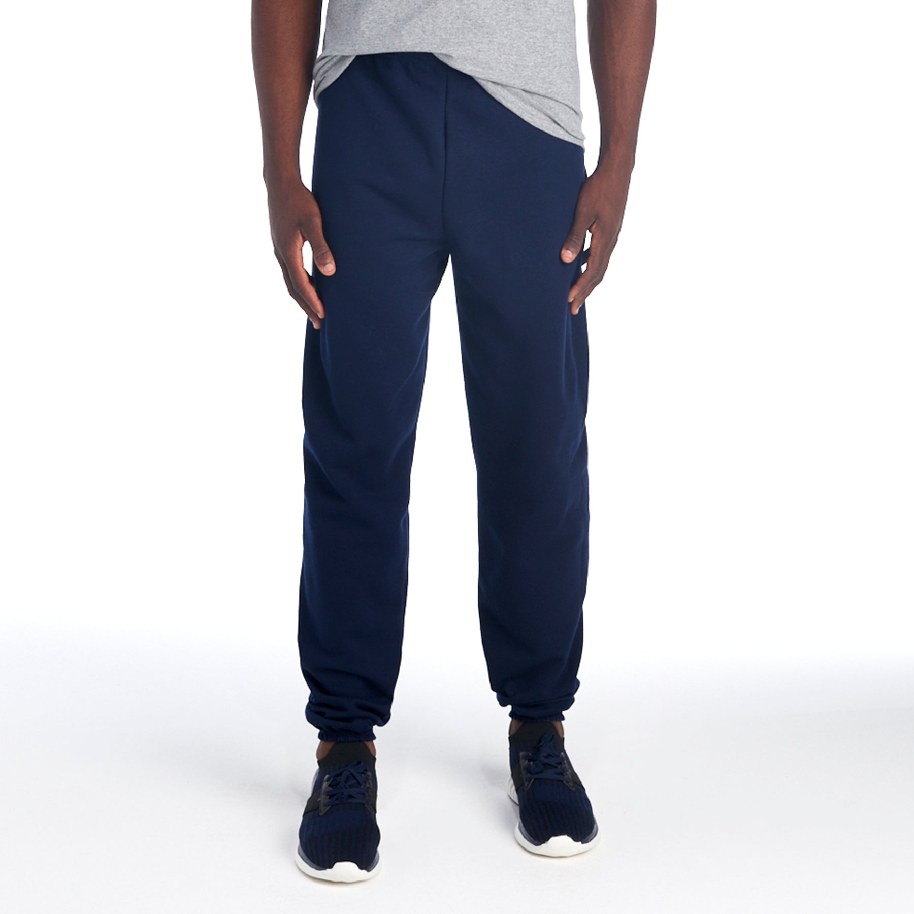 Jerzees NuBlend Adult Sweatpants in J. Navy worn by a man with a grey t-shirt and blue athletic shoes.