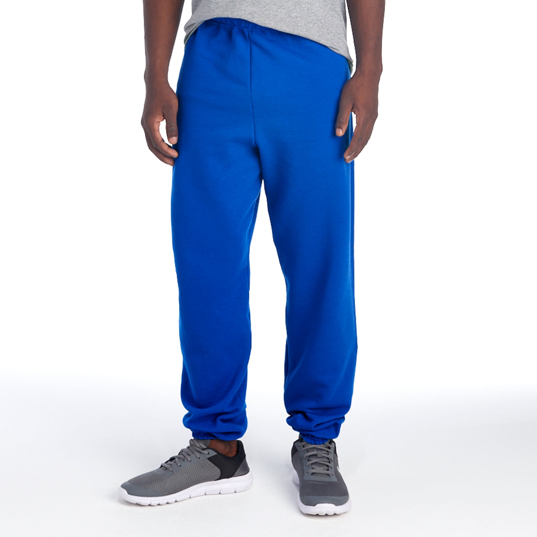 Jerzees NuBlend Adult Sweatpants in Royal blue, worn by a man with gray sneakers against a white background.
