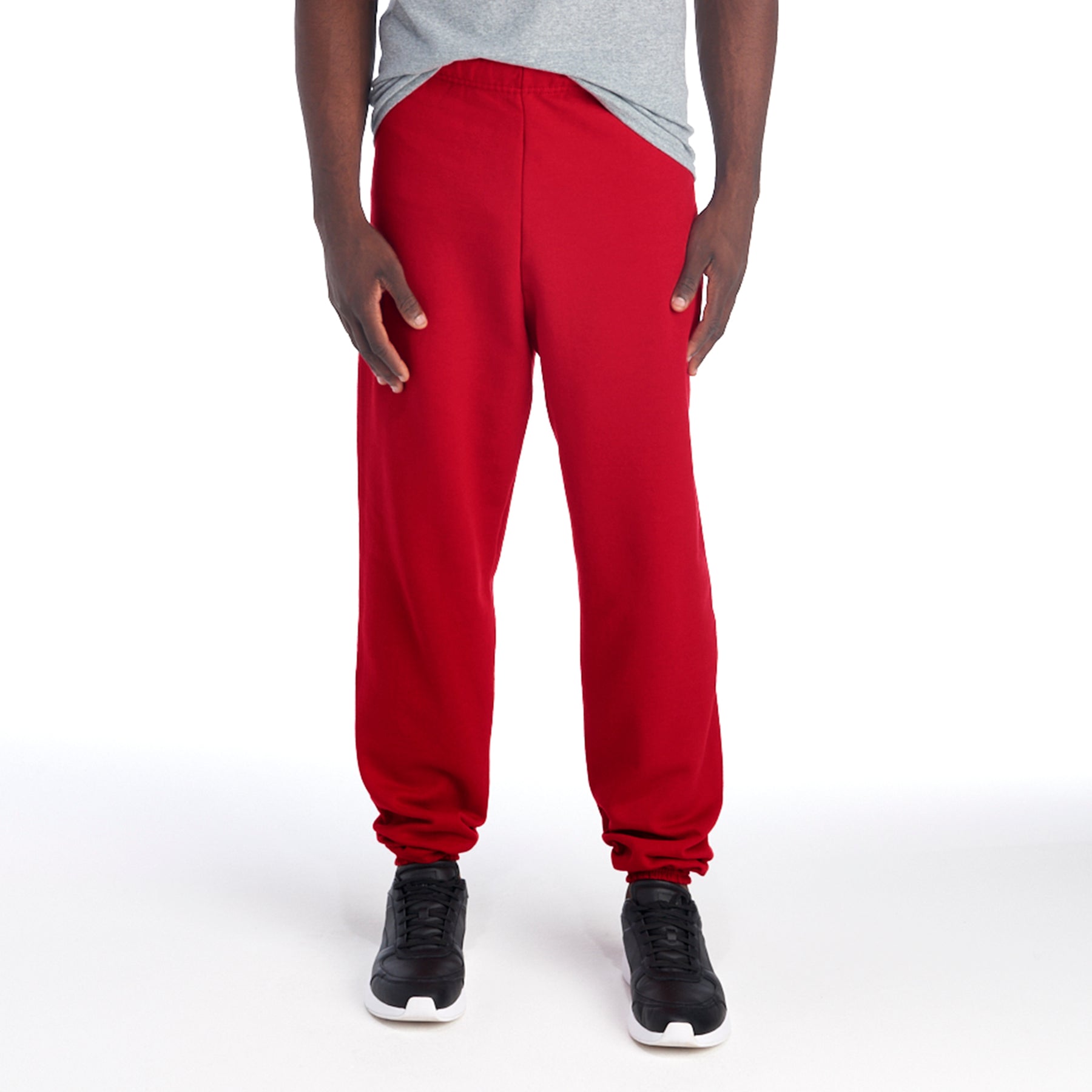 Model wearing Jerzees NuBlend Adult Sweatpants in True Red paired with a gray t-shirt and black sneakers.