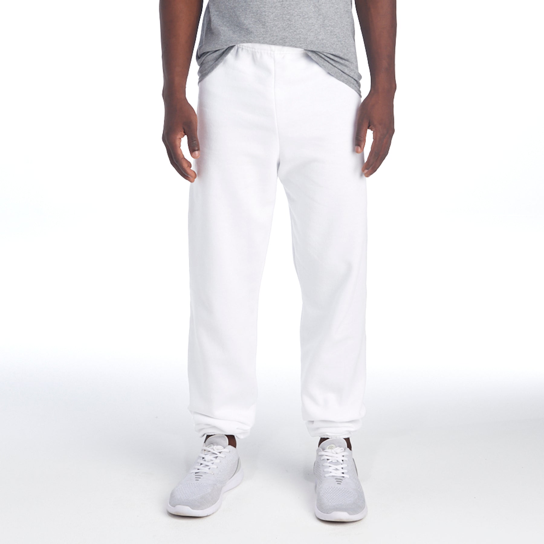 Jerzees NuBlend Adult Sweatpants in white worn by a person with a grey t-shirt and white sneakers.