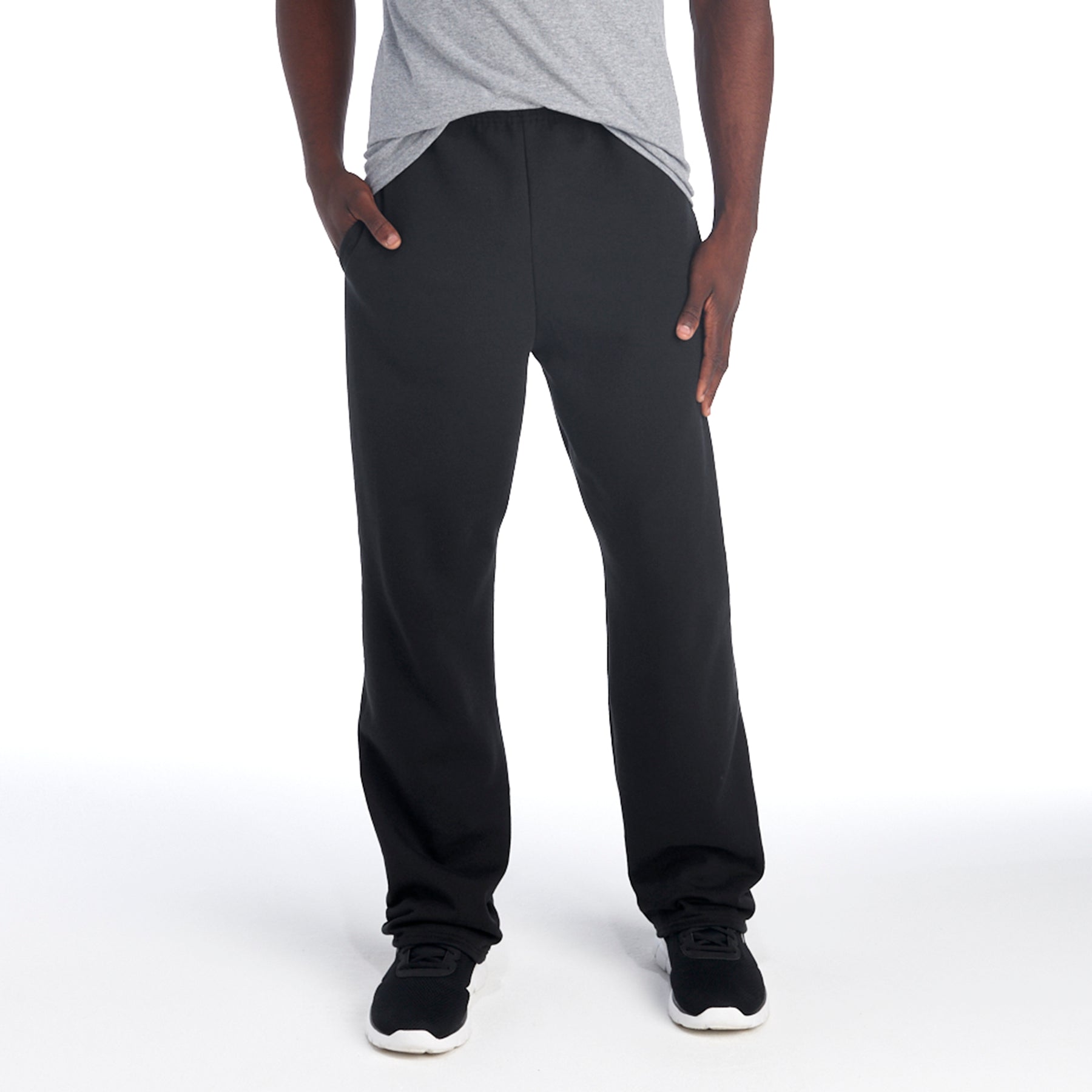 Jerzees NuBlend® black pocketed open-bottom sweatpants worn by a model in a gray t-shirt.
