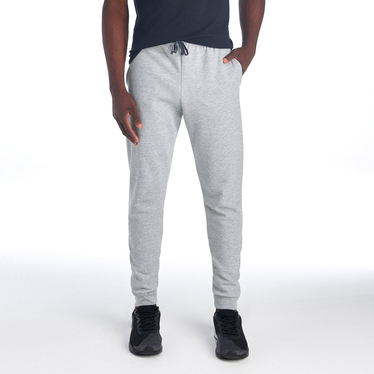 Jerzees NuBlend Adult Pocketed Jogger Sweatpants in Athletic Heather worn by a model.