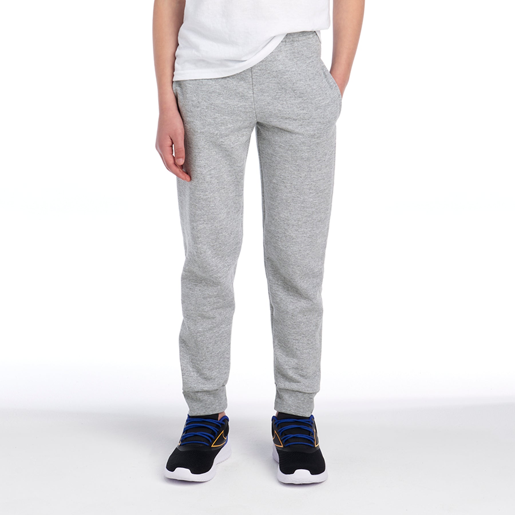 Youth wearing Jerzees NuBlend® Pocketed Jogger Sweatpants in Athletic Heather against a white background.