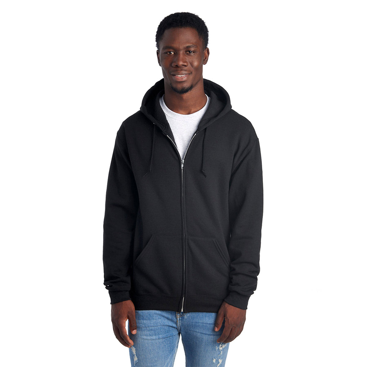 Man wearing a black Jerzees NuBlend Unisex Full-Zip Hooded Sweatshirt over a white t-shirt and blue jeans.