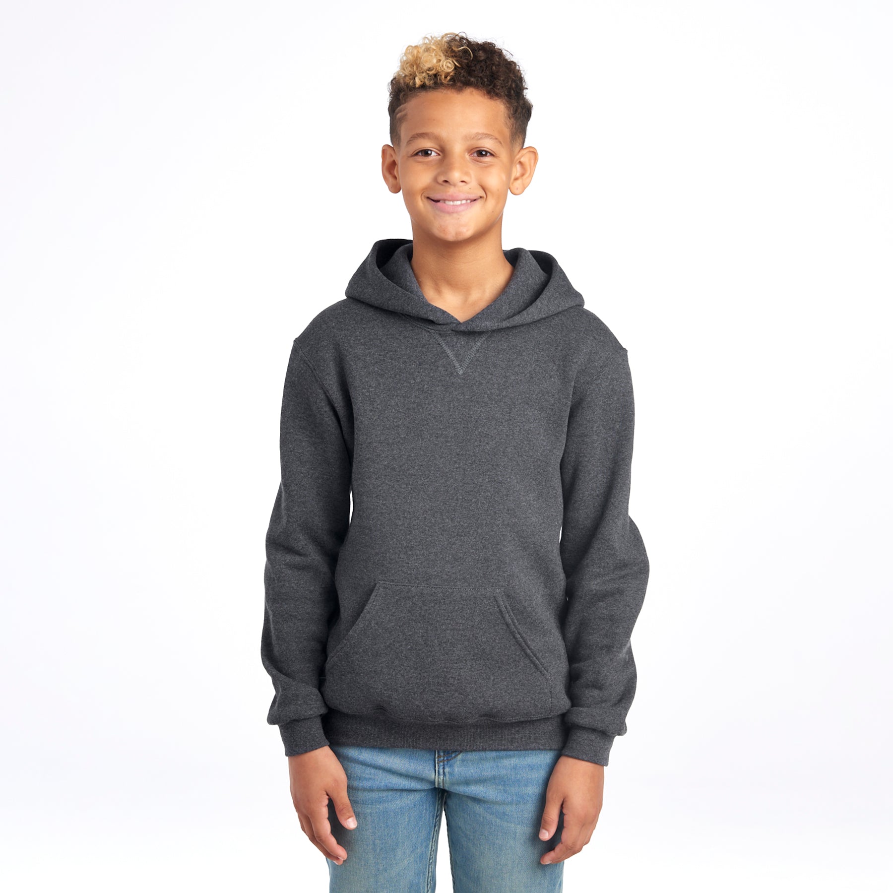 A young boy wearing a Russell Athletic DRI-POWER Youth Fleece Pullover Hoodie in Black Heather.