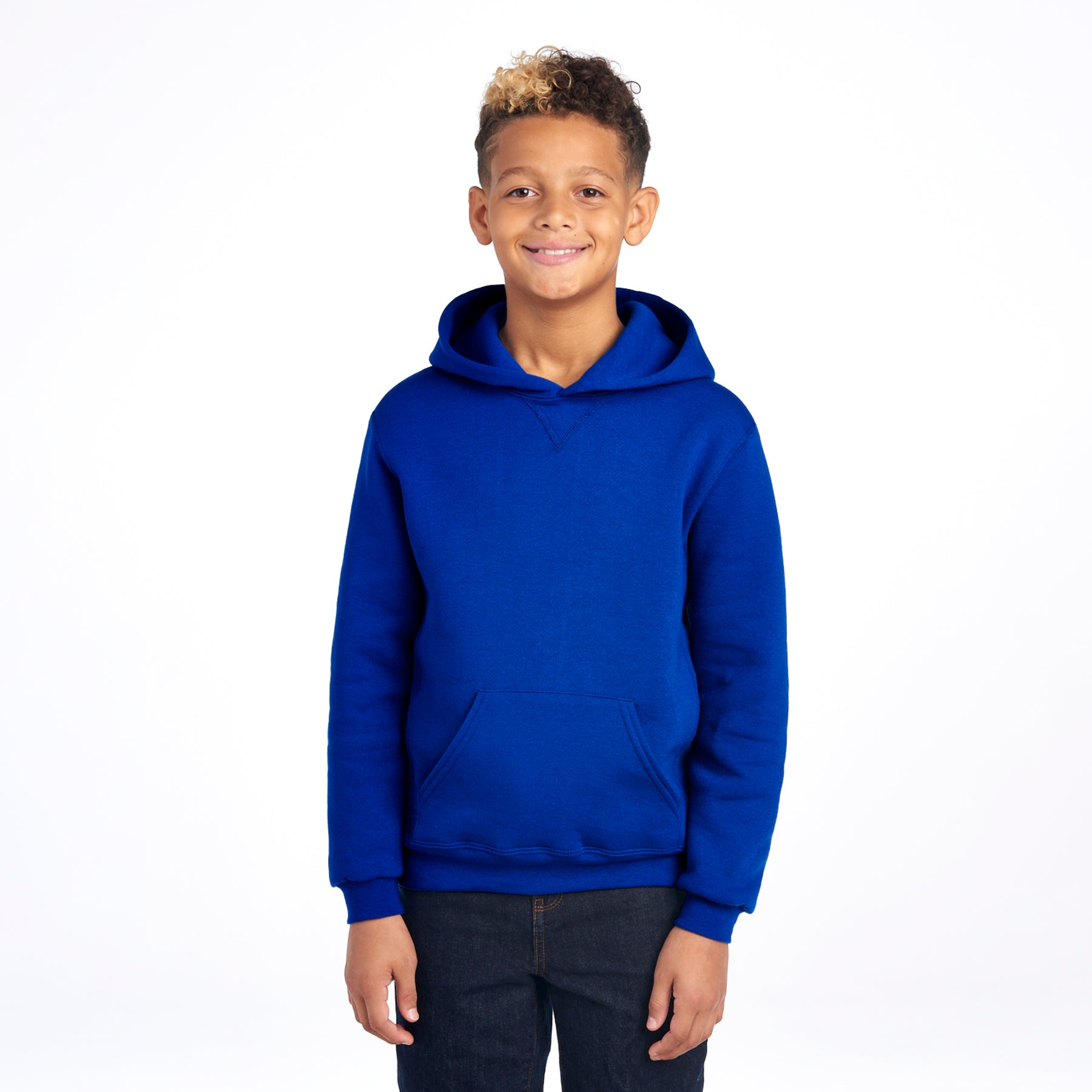 Youth boy smiling while wearing a royal blue Russell Athletic DRI-POWER® fleece pullover hoodie.