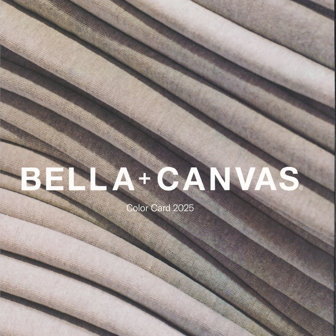 Bella+Canvas 2025 Swatch Card featuring a stack of folded fabric in neutral, heathered tones.