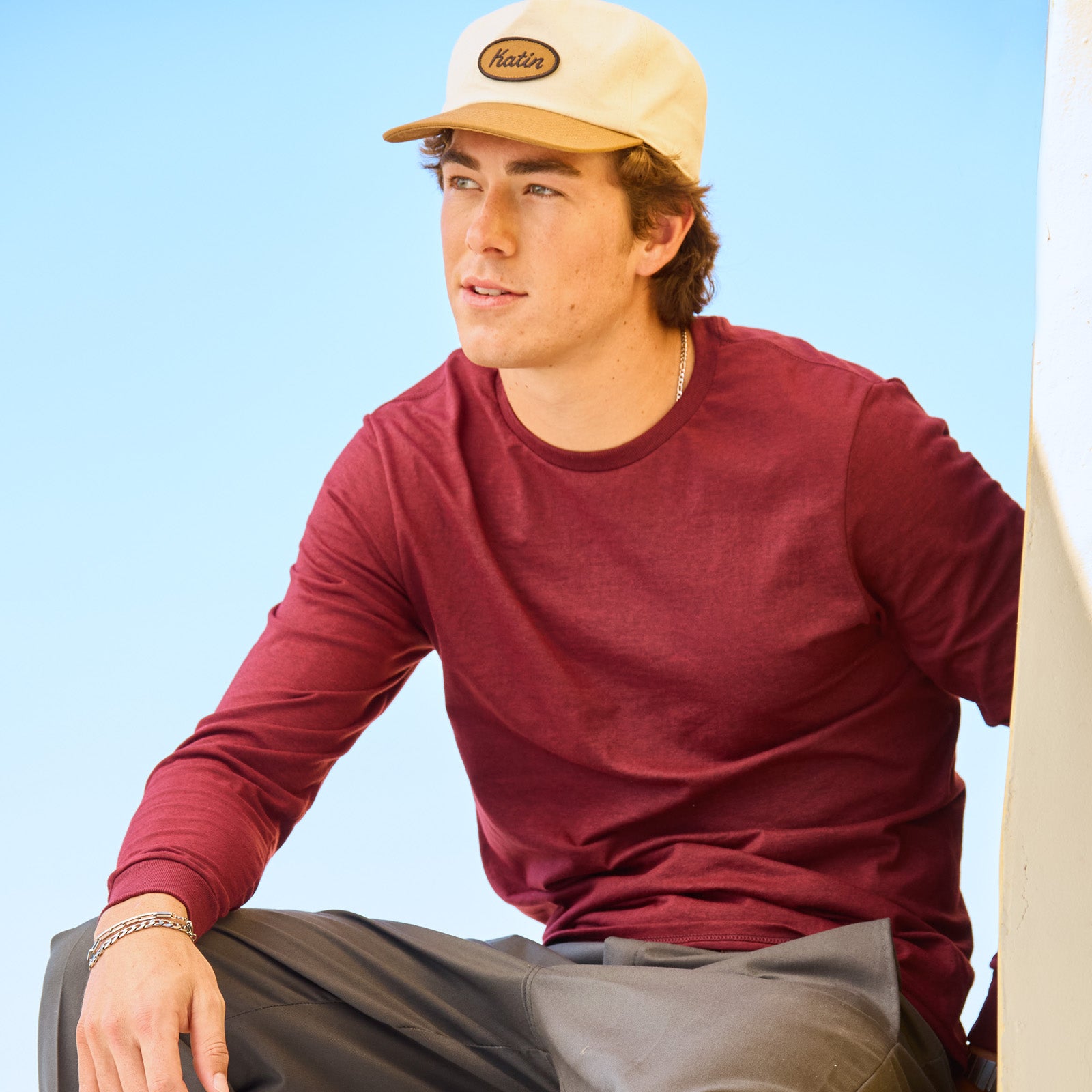 Young man wearing a maroon heather Jerzees Premium Blend Combed Ring-Spun unisex long-sleeve T-shirt.