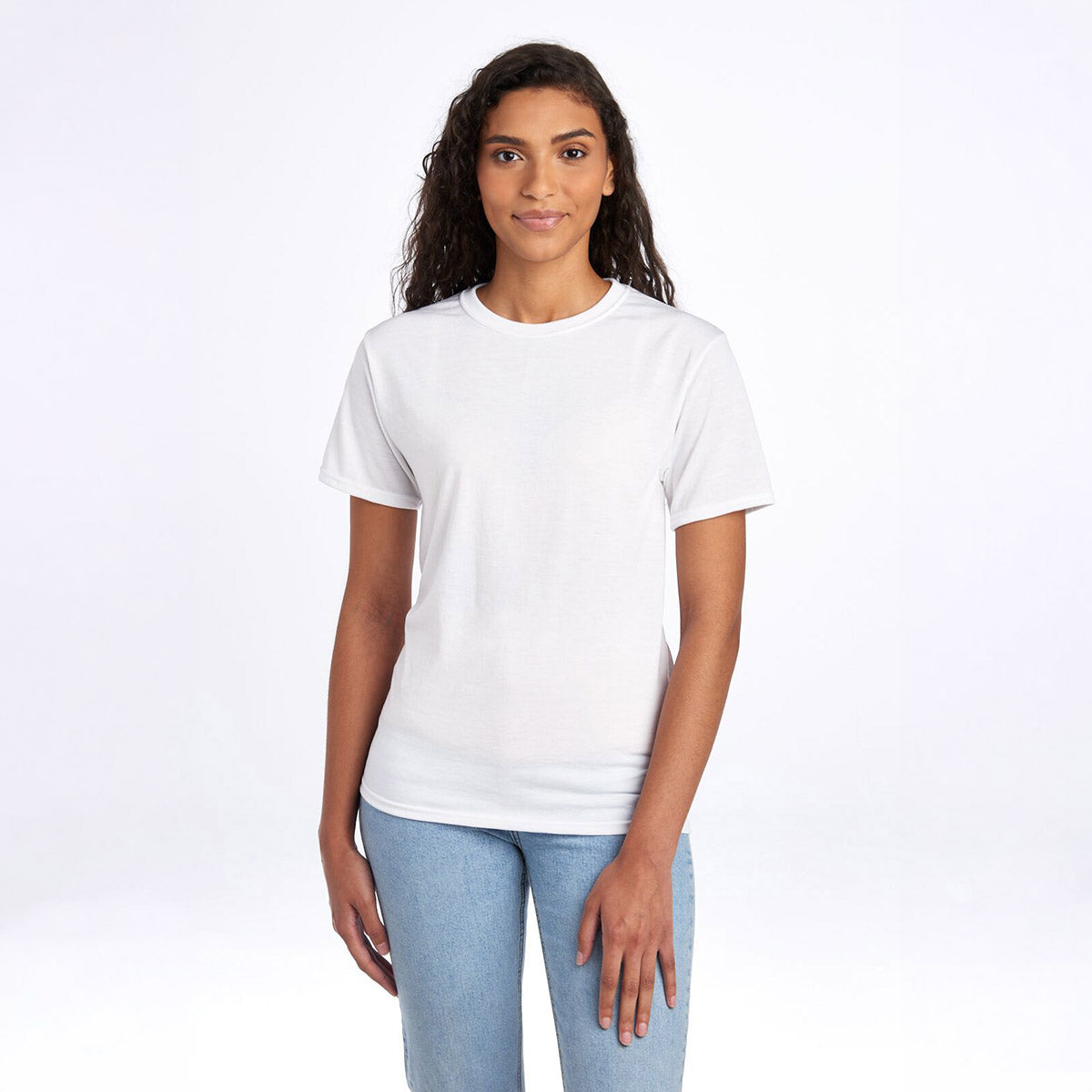A woman wearing a white Jerzees Dri-Power Unisex T-Shirt paired with blue jeans against a white background.