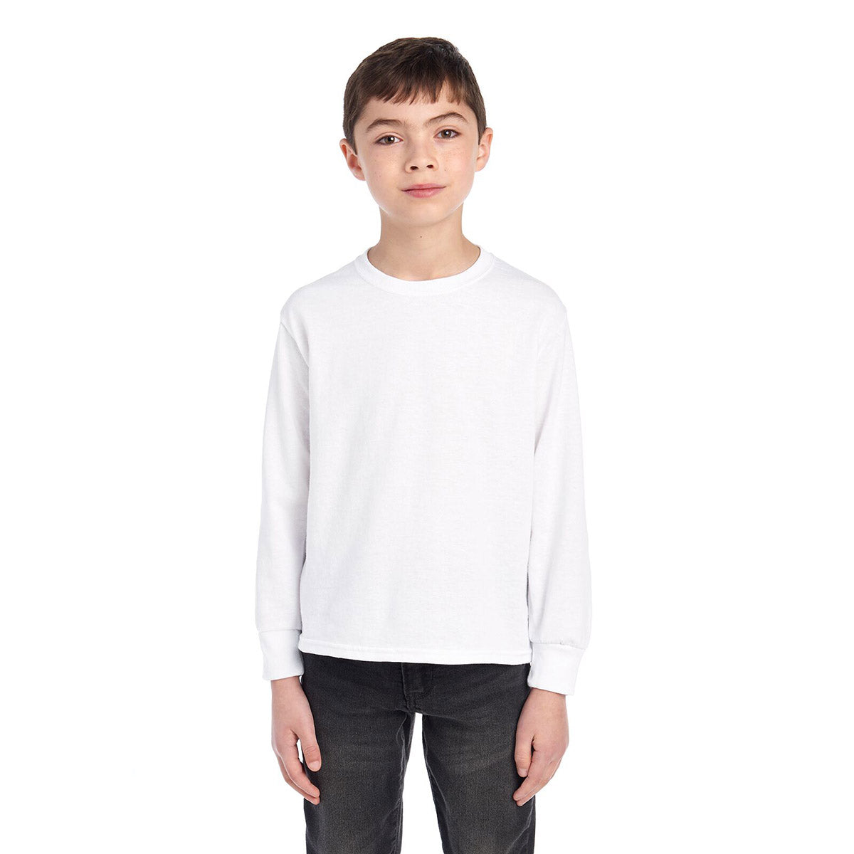 Young boy wearing a white Jerzees Dri-Power Youth Long-Sleeve T-Shirt against a white background.