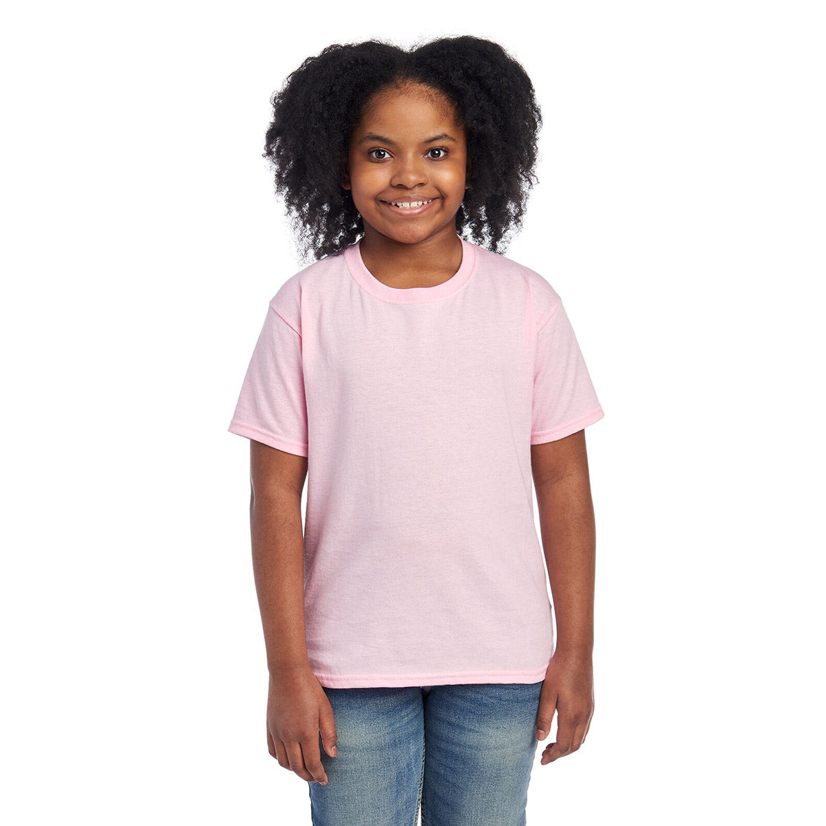 Youth girl smiling while wearing a Classic Pink Jerzees Dri-Power youth T-shirt.