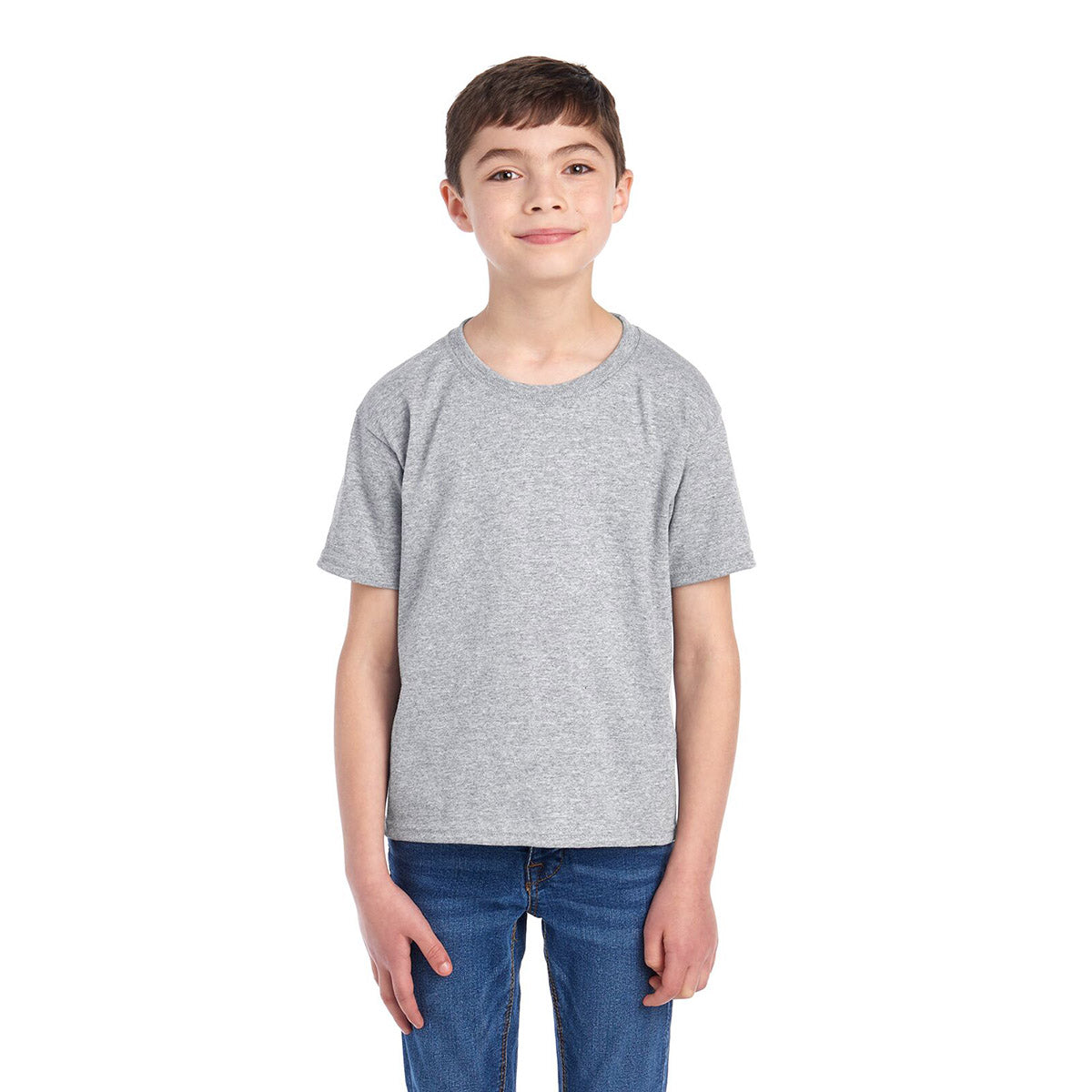 A young boy wearing a Jerzees Dri-Power Youth T-Shirt in oxford gray with blue jeans.