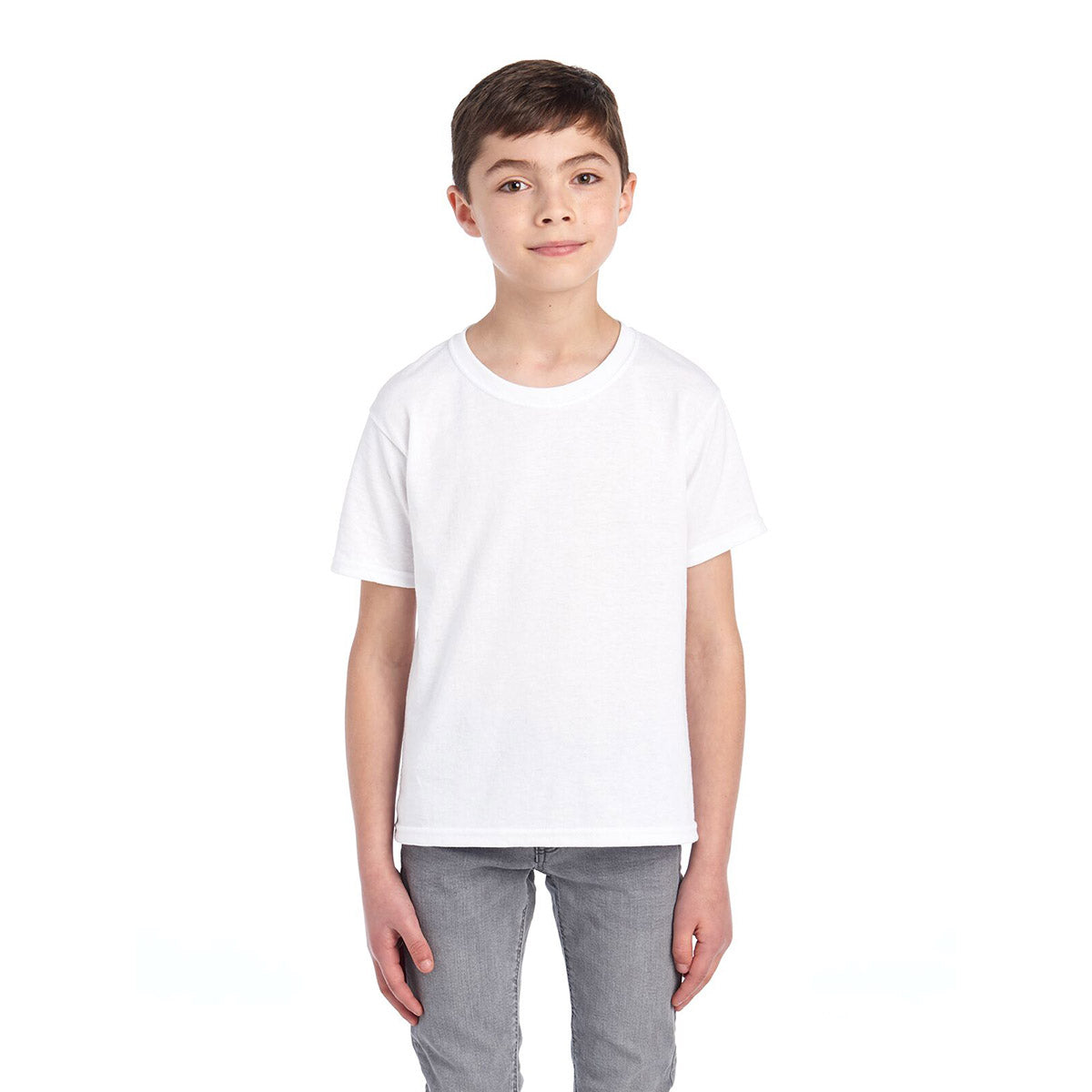 A young boy wearing a white Jerzees Dri-Power Youth T-Shirt standing against a white background.