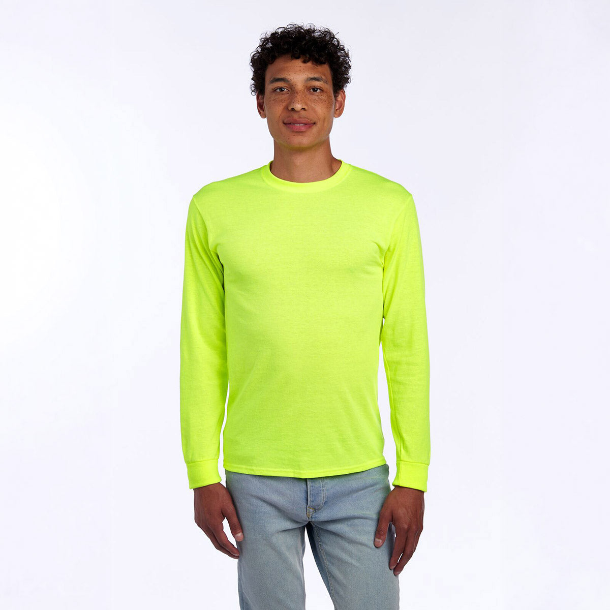 Model wearing a Safety Green Jerzees Dri-Power Unisex Long-Sleeve T-Shirt against a white background.