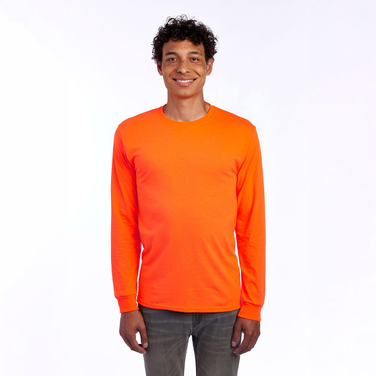 A man wearing a Jerzees Dri-Power unisex long-sleeve T-shirt in safety orange against a white background.