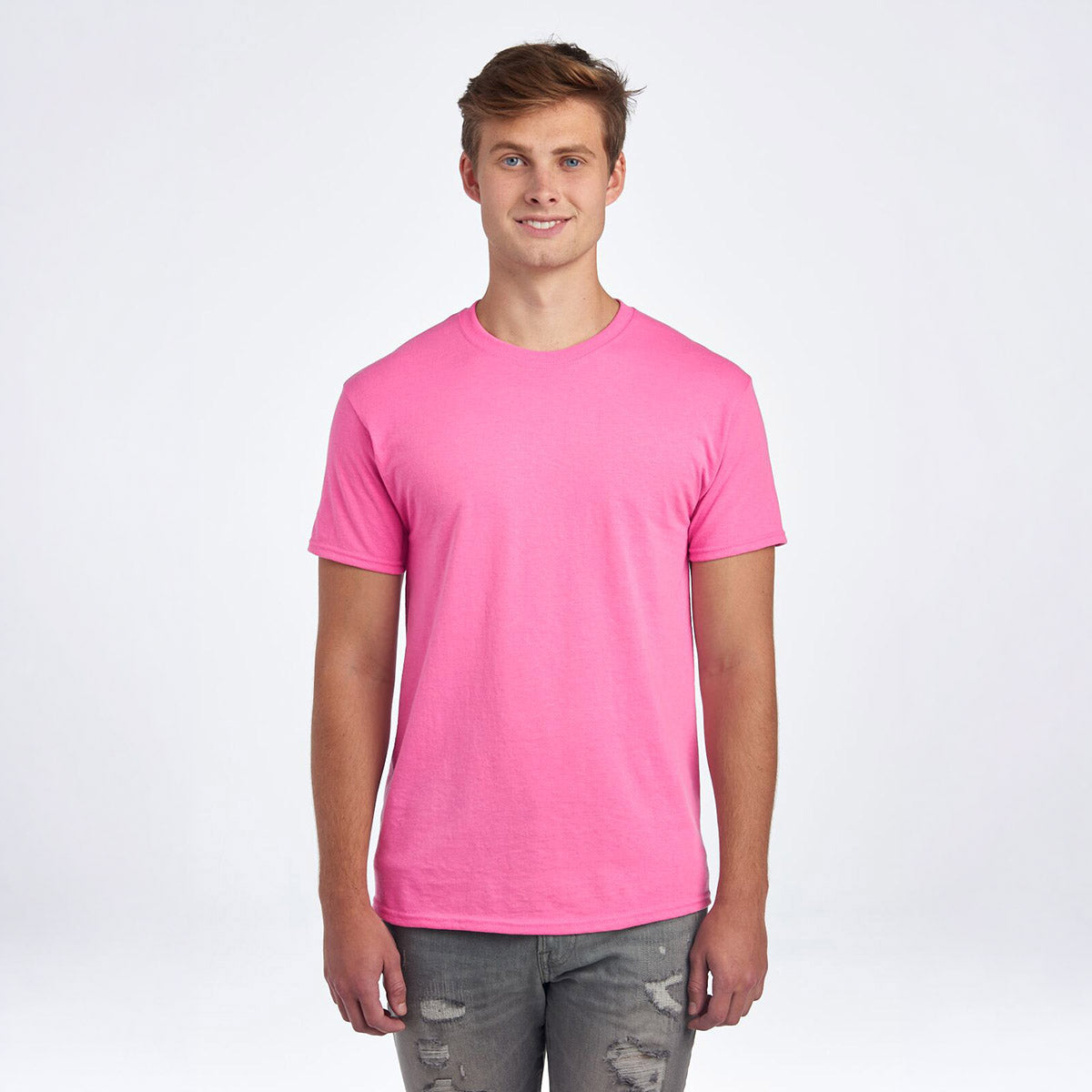 A model wearing a Jerzees Dri-Power Unisex T-Shirt in azalea pink against a white background.