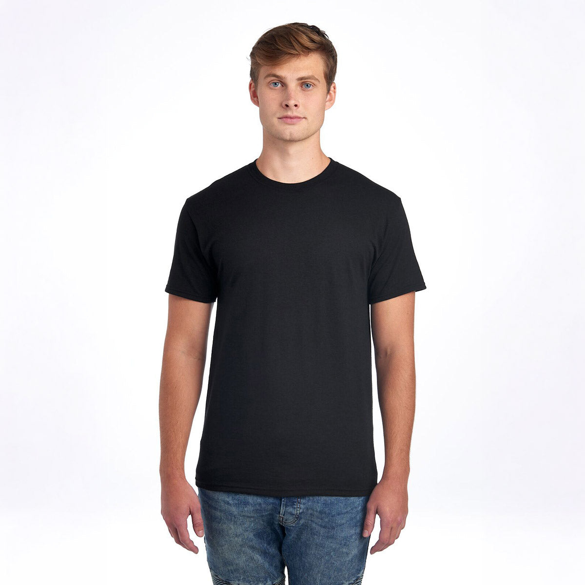 A young man wearing a black Jerzees Dri-Power unisex crewneck t-shirt standing against a white background.