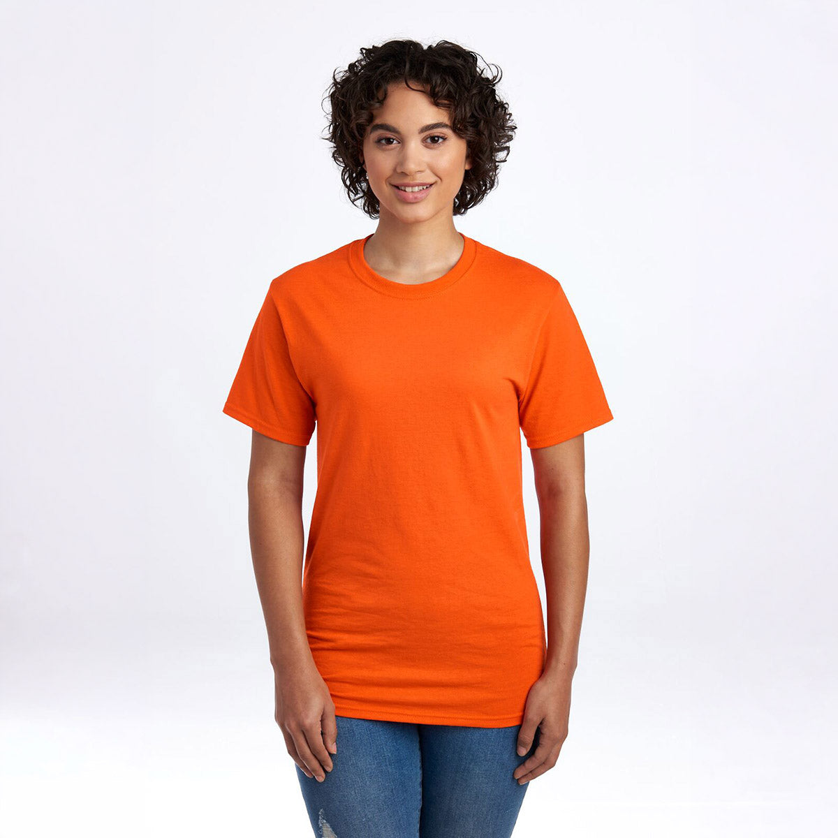 A person wearing a burnt orange Jerzees Dri-Power unisex crewneck t-shirt against a white background.