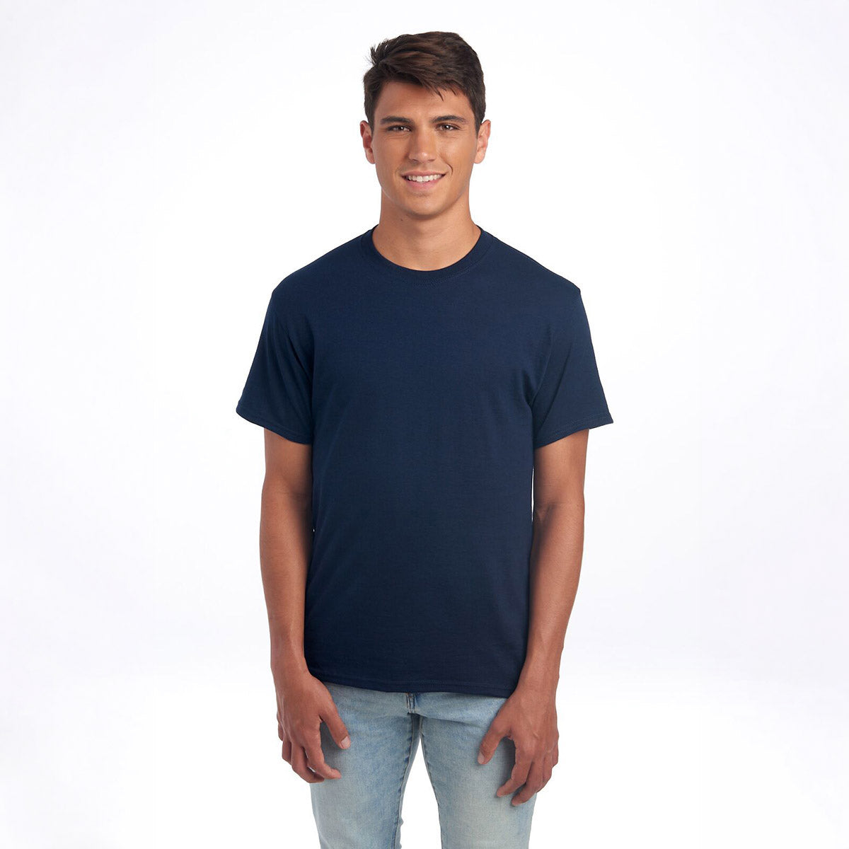 A young man wearing a Jerzees Dri-Power Unisex T-Shirt in J. Navy standing against a white background.