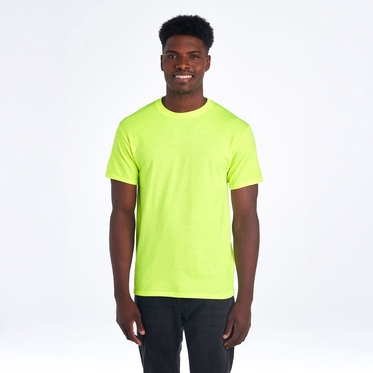 A smiling man wearing a Safety Green Jerzees Dri-Power Unisex T-Shirt against a white background.