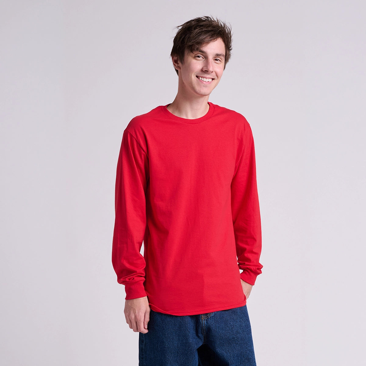 Person wearing a red long-sleeve shirt on a plain background