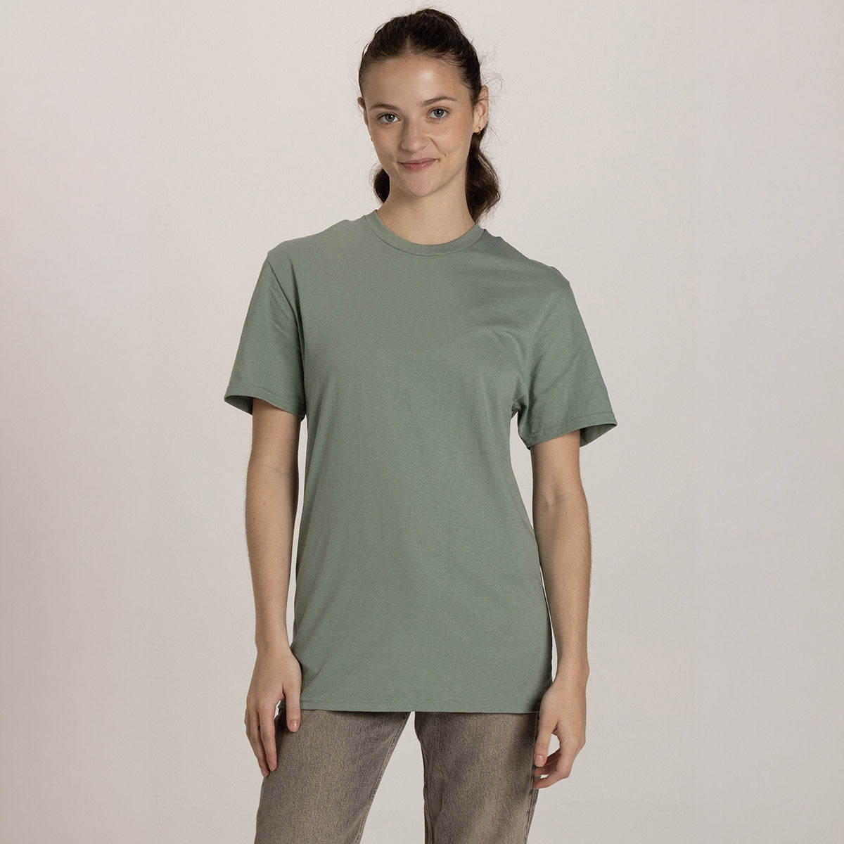 Woman wearing a sage stone Jerzees Classics unisex t-shirt.