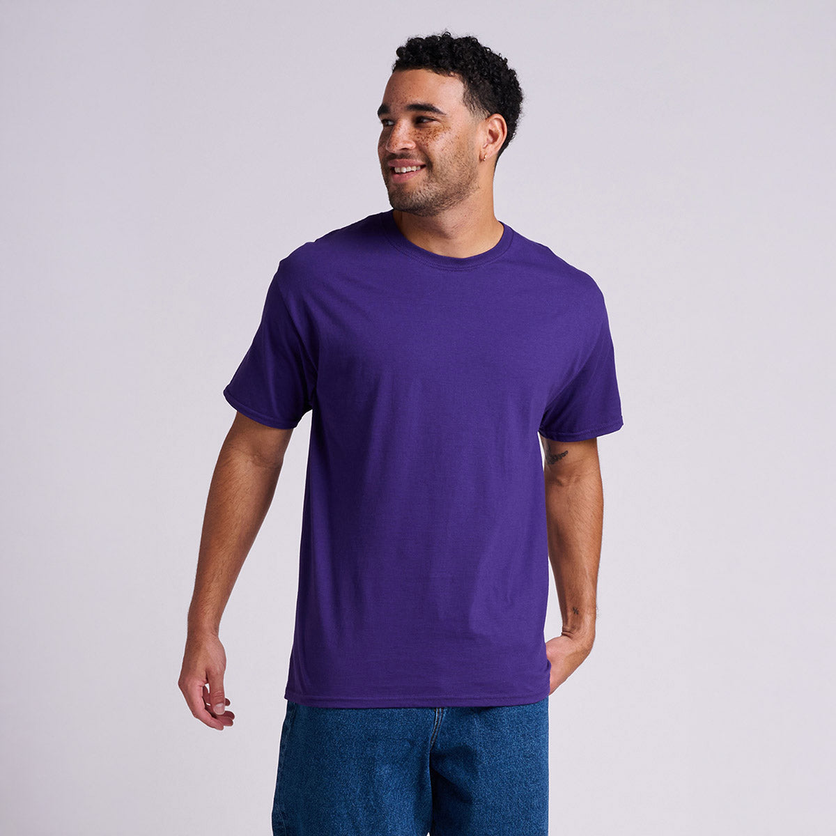 Man wearing a deep purple Jerzees Classics unisex t-shirt.
