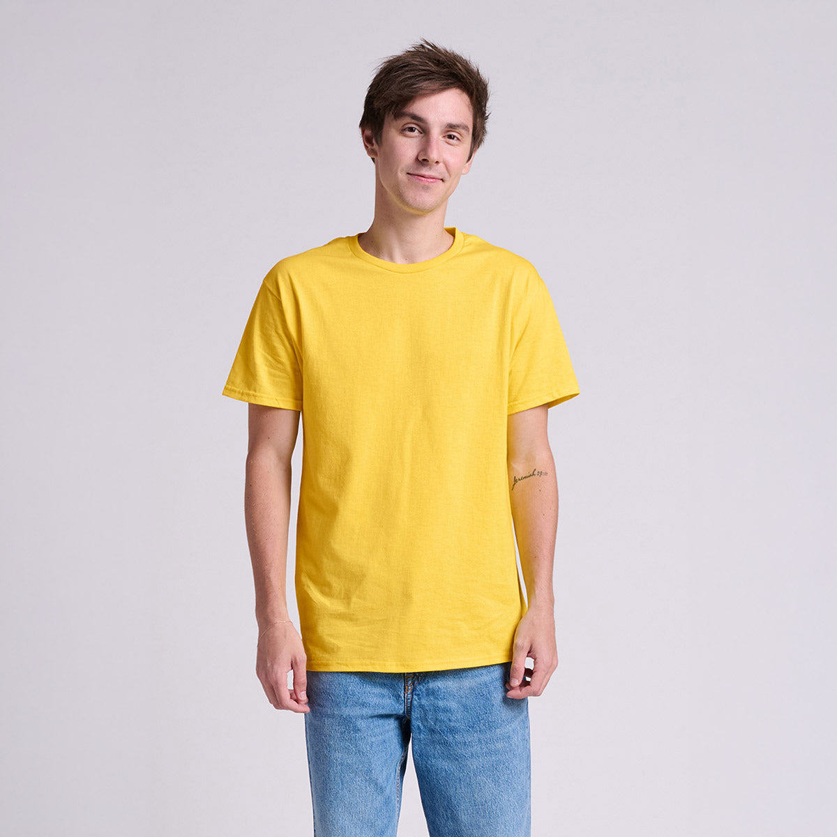 Man wearing a Jerzees Classics Unisex T-Shirt in Island Yellow against a plain white background.