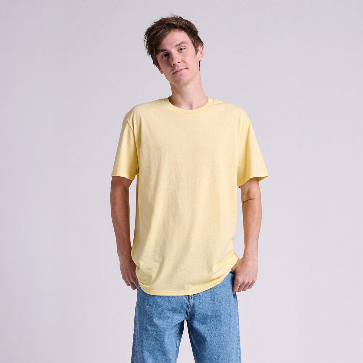 Jerzees Classics Unisex T-Shirt in surf yellow, worn by a young man with blue jeans.