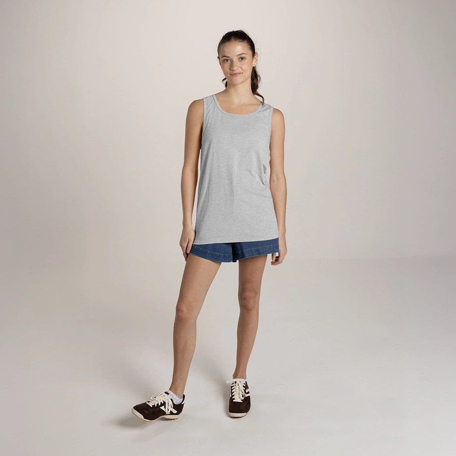 A model wears a JERZEES Classics™ Unisex Tank in Athletic Heather with denim shorts and sneakers.