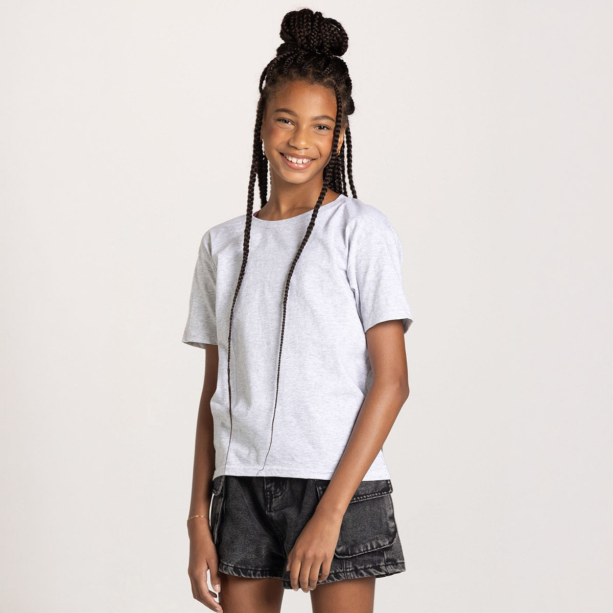 A young girl wearing an Ash-colored Jerzees Classics Youth T-Shirt against a white background.