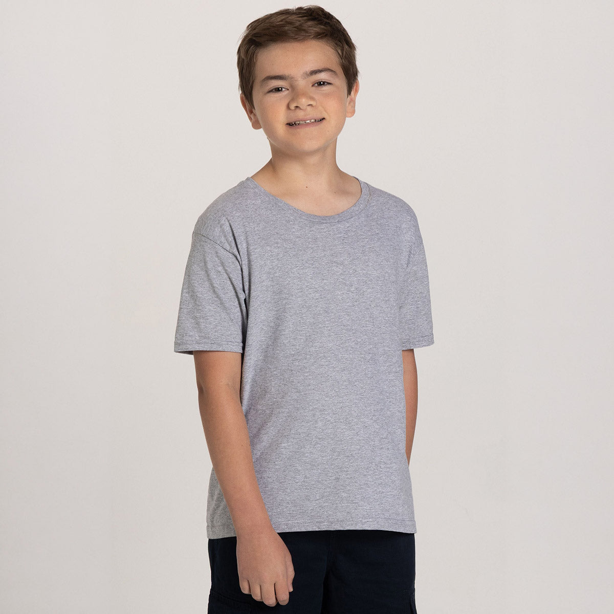 A youth model wearing a Jerzees Classics youth t-shirt in athletic heather against a plain white background.