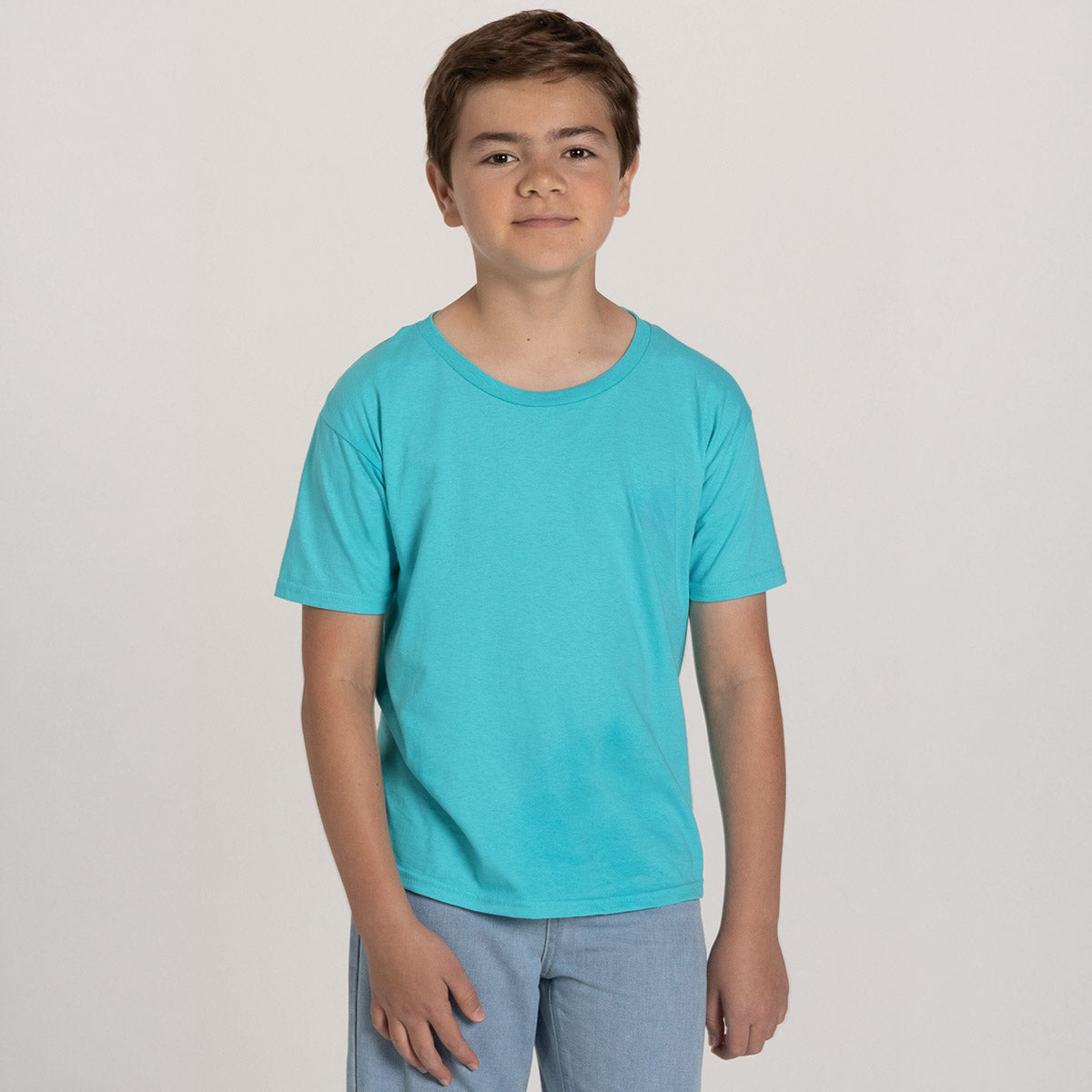 A youth boy wearing a Jerzees Classics youth t-shirt in Scuba Blue against a plain white background.