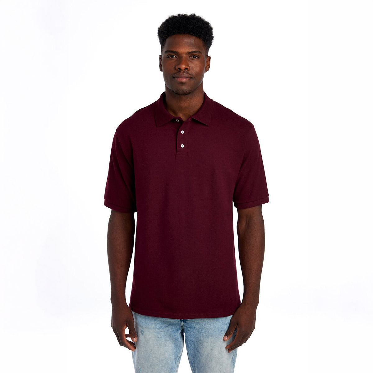 A man wearing a maroon Jerzees Premium Ring-Spun Cotton Pique Sport Shirt against a white background.