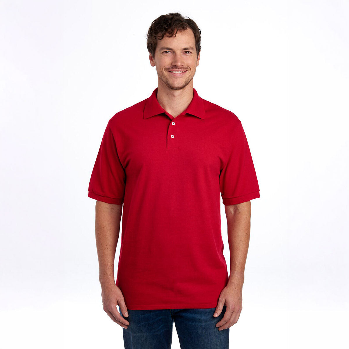 A man wearing a Jerzees Premium Ring-Spun Cotton Pique Sport Shirt in True Red with jeans.