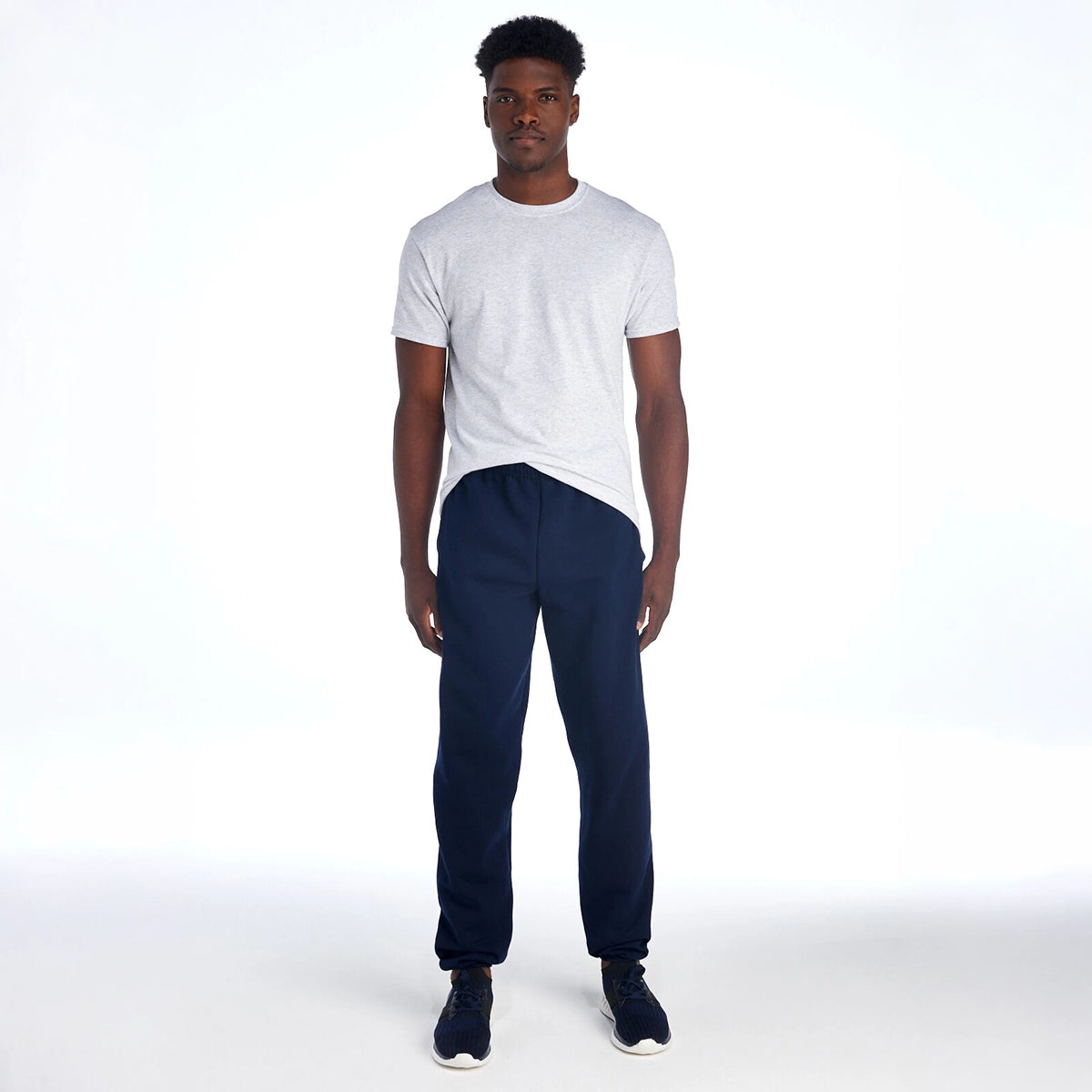 Model wearing Jerzees Super Sweats® NuBlend® Pocketed Sweatpants in J. Navy with a grey t-shirt.