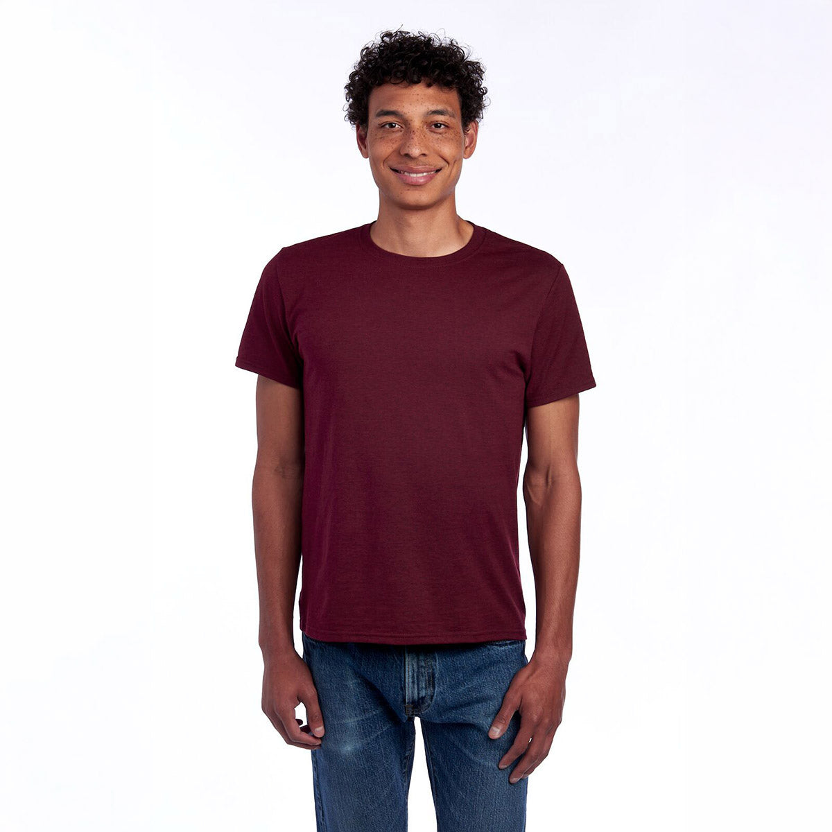 A person wearing a Maroon Heather Jerzees Premium Blend Combed Ring-Spun unisex t-shirt against a white background.