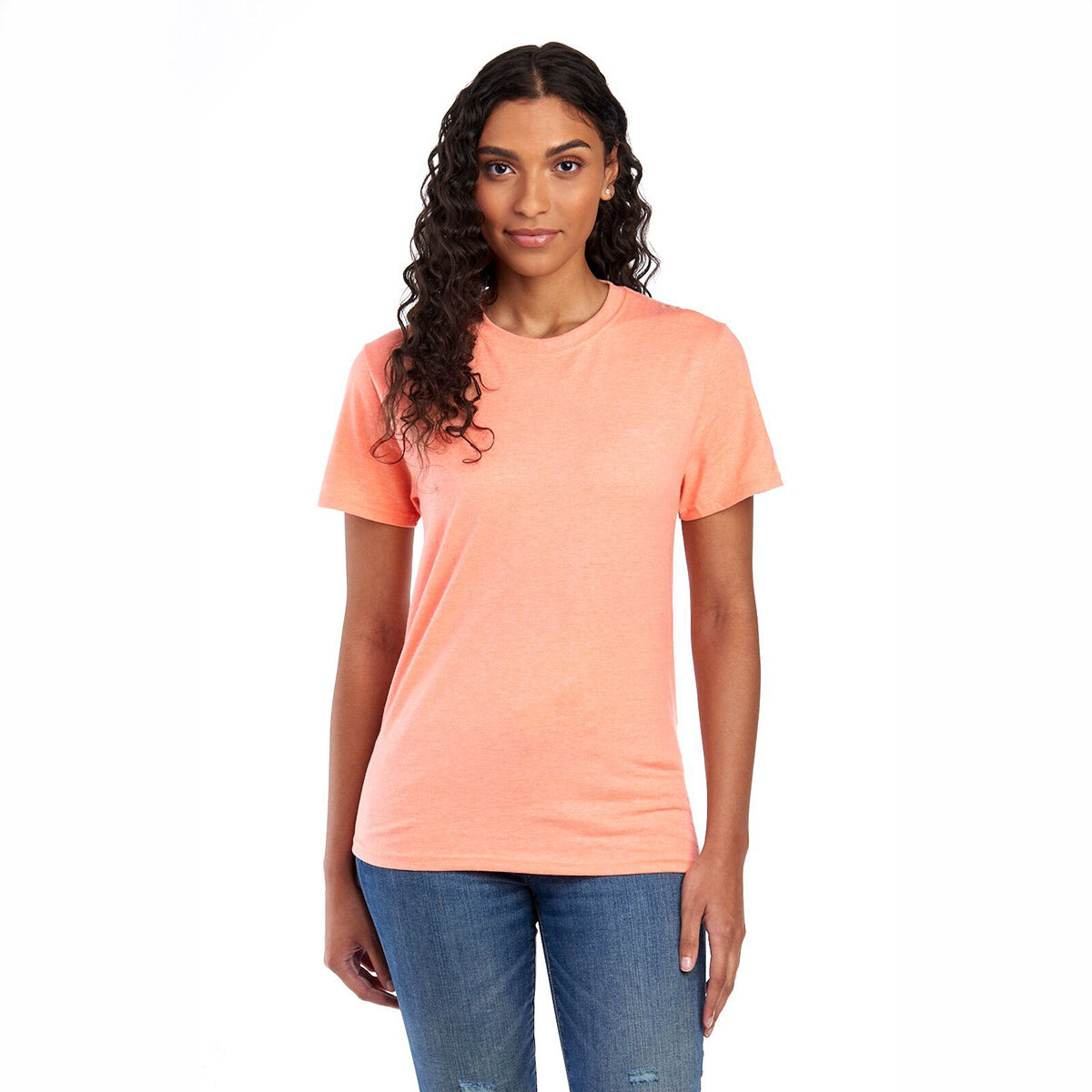 A woman wearing a peach Jerzees Premium Blend Combed Ring-Spun unisex T-shirt.